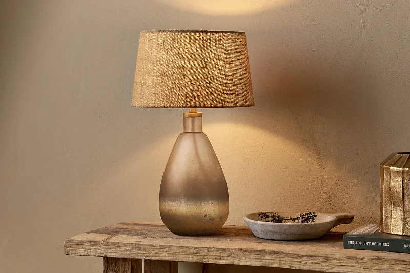 African - Inspired Ceiling Lights with Tribal Patterns and Natural MaterialsAfrican - Inspired Ceiling Lights with Tribal Patterns and Natural MaterialsPalla Recycled Glass Table Lamp - Rustic Smoke